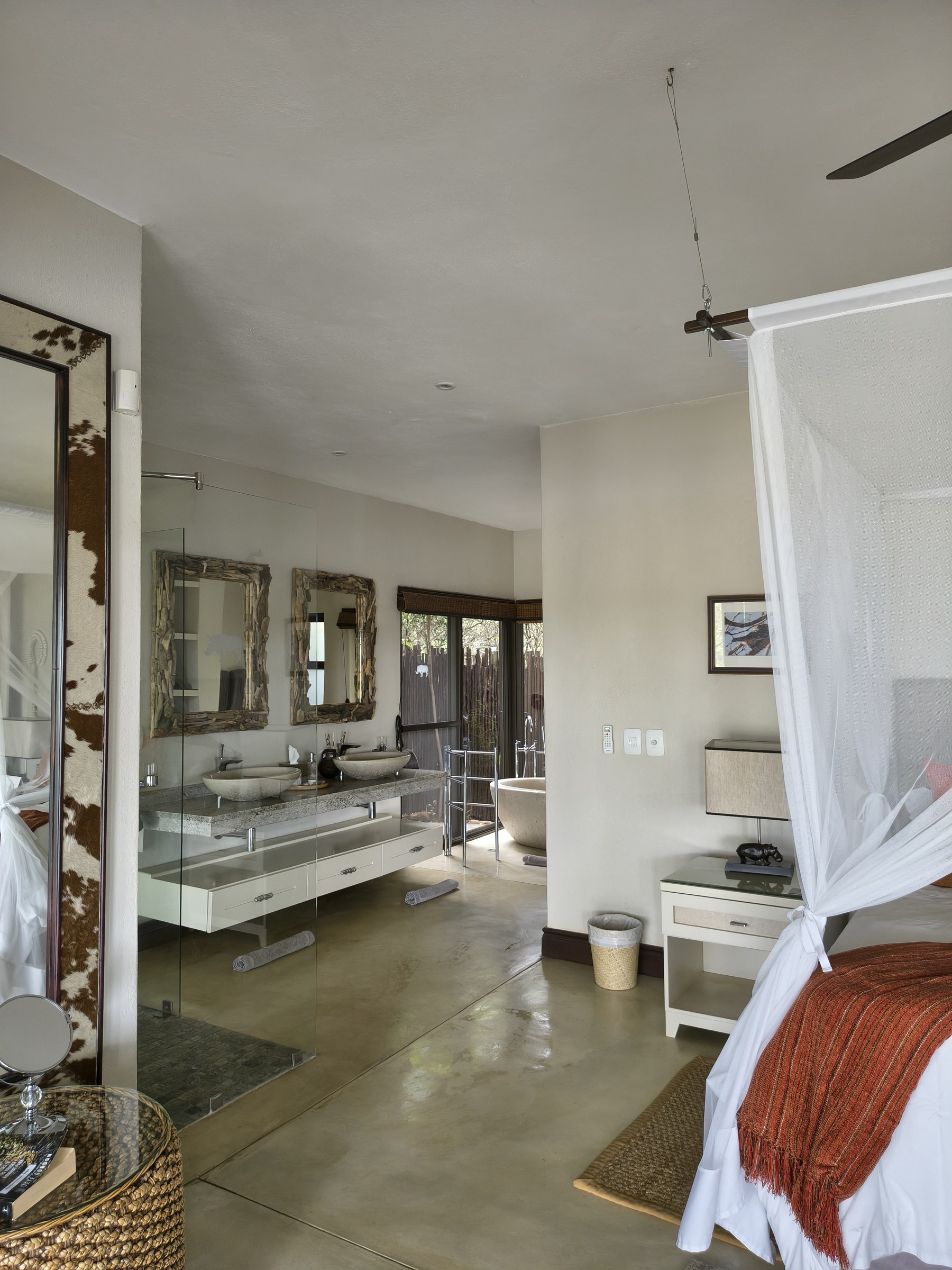 An en-suite bathroom with twin driftwood-framed vanities