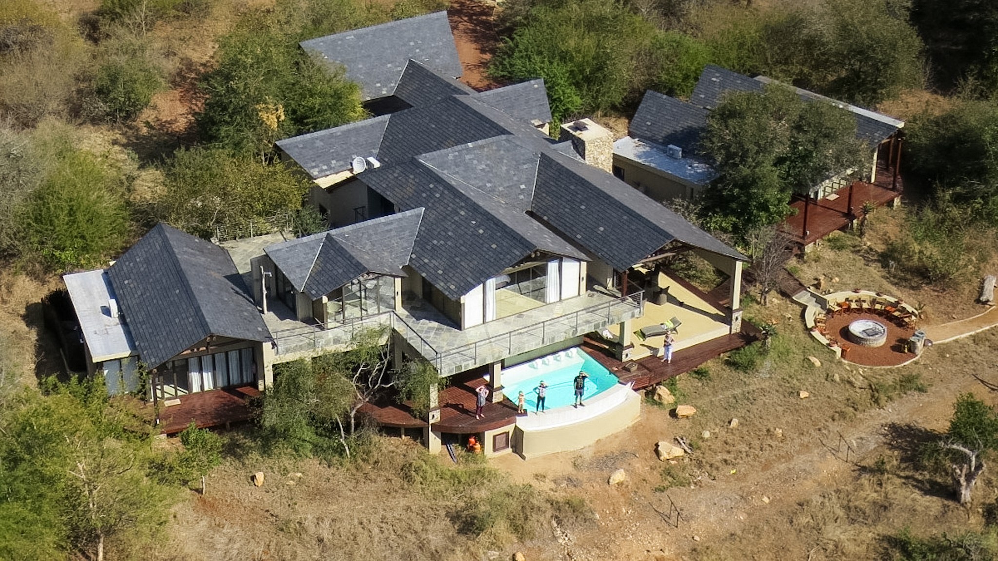Aerial view of Ngulube River Lodge — angular slate roofs, pool and boma set into the bushveld